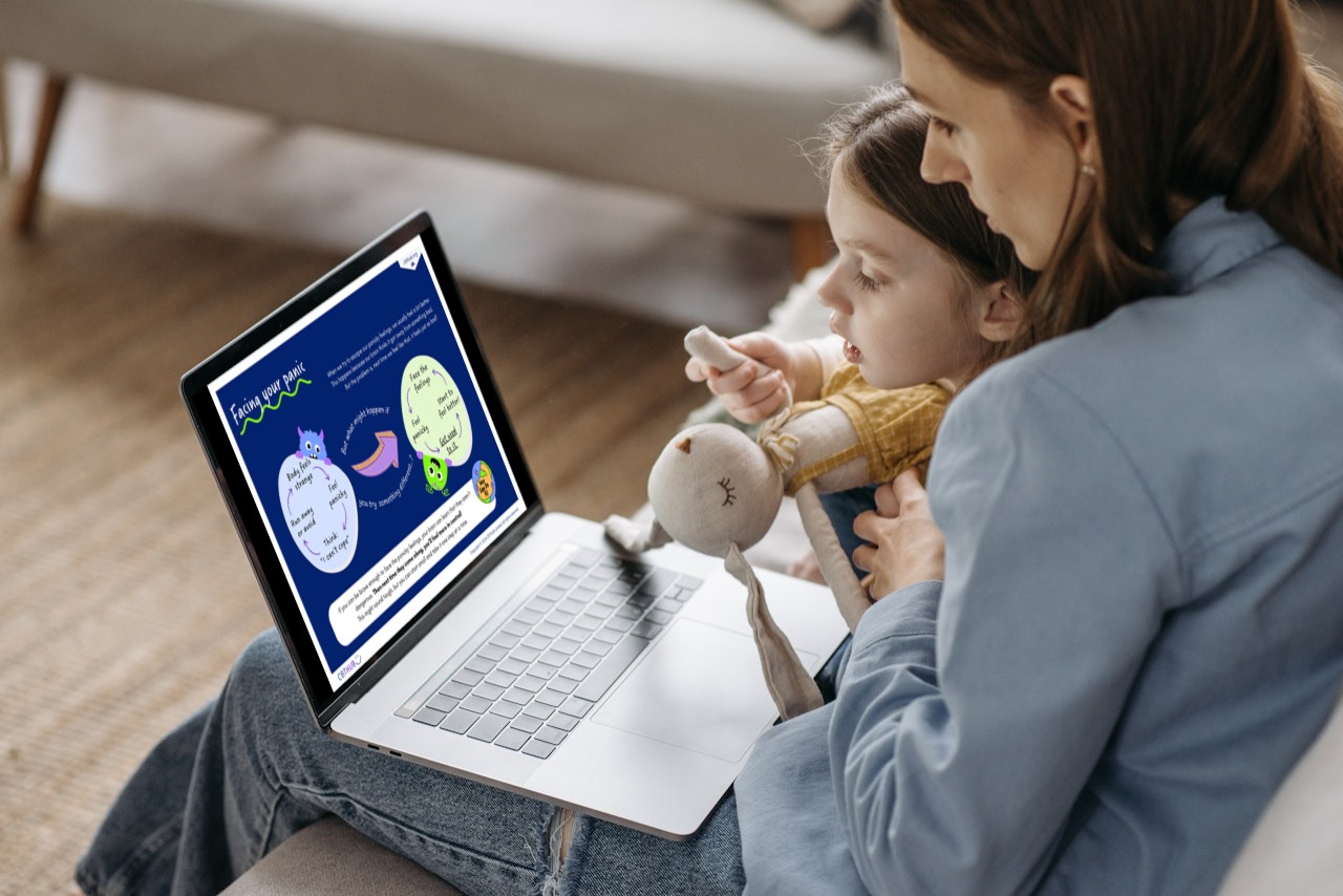 Parent and child using a laptop displaying a CBT worksheet with interactive activities for emotional well-being.